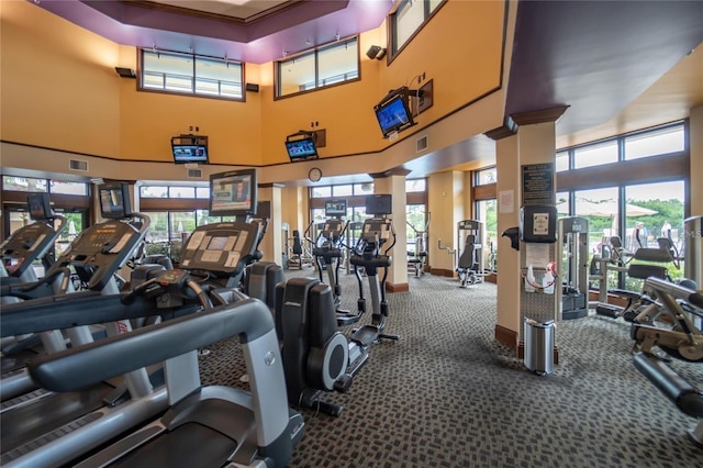 gym with carpet floors and a high ceiling