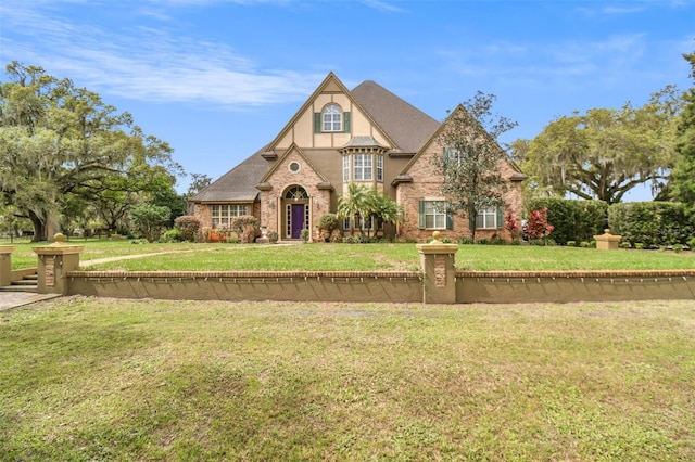 tudor home featuring a front lawn