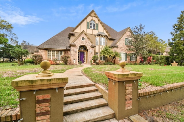 tudor-style house with a front yard