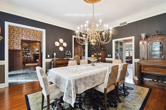 dining room with crown molding, a notable chandelier, and dark hardwood / wood-style flooring