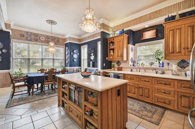 kitchen with a kitchen island, stainless steel dishwasher, a chandelier, and decorative light fixtures