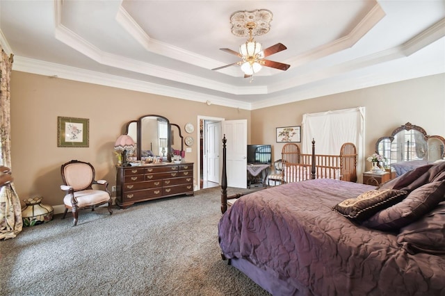 carpeted bedroom with a raised ceiling and crown molding