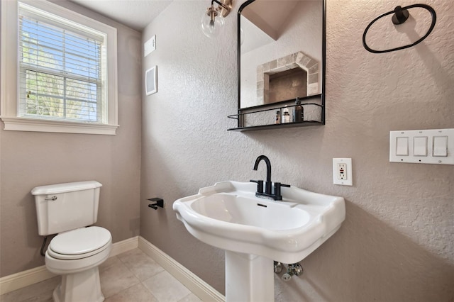 bathroom featuring tile patterned flooring and toilet