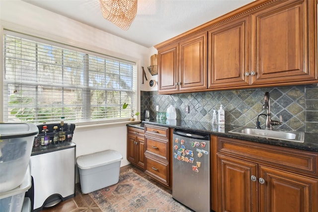 kitchen featuring tasteful backsplash, fridge, sink, and dark stone countertops