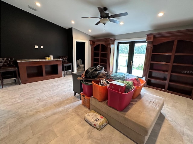 living room with lofted ceiling, ceiling fan, and french doors