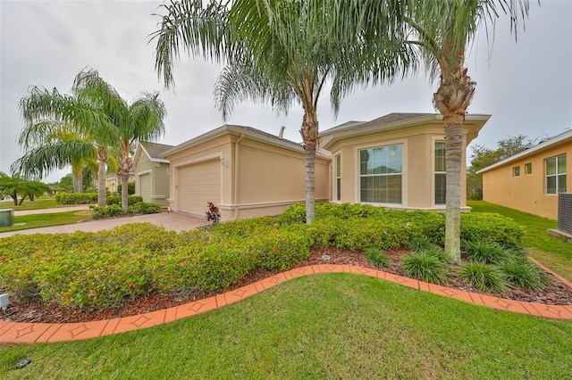 view of front of house with a front yard and a garage