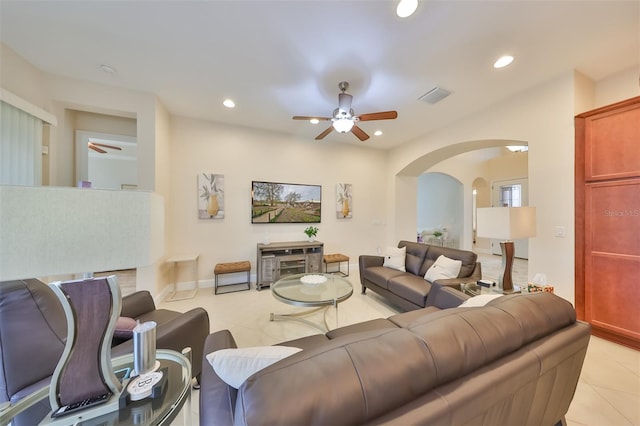 tiled living room with ceiling fan