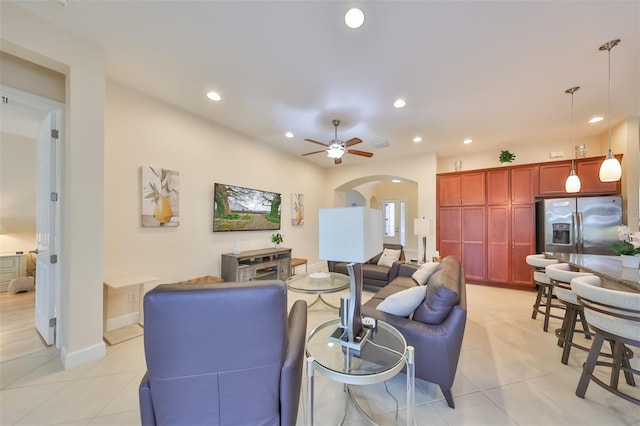 tiled living room with ceiling fan