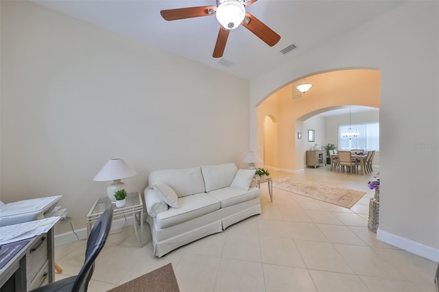 tiled living room with ceiling fan