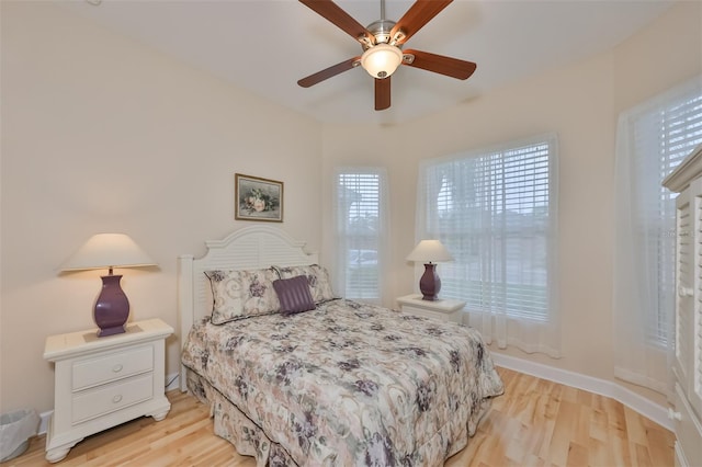 bedroom with light hardwood / wood-style flooring and ceiling fan