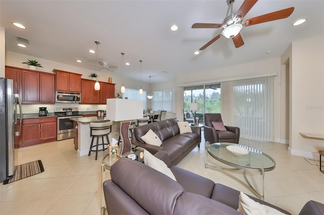 tiled living room featuring ceiling fan