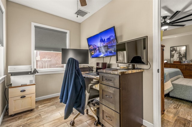 office with light hardwood / wood-style flooring and ceiling fan