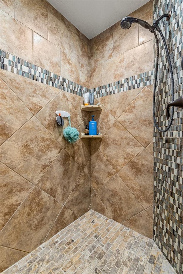 bathroom with tiled shower