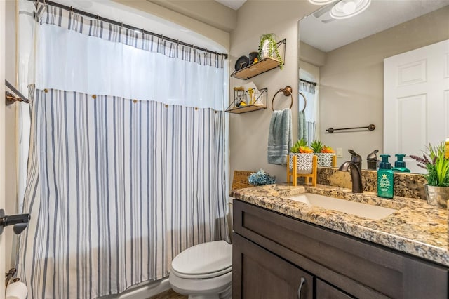 bathroom with toilet and vanity