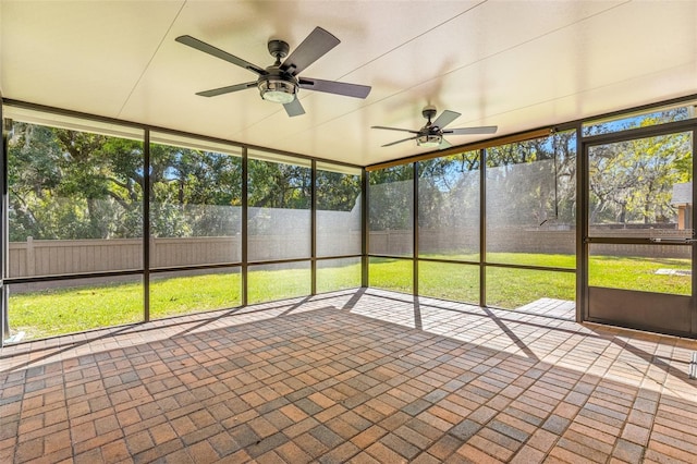 unfurnished sunroom featuring ceiling fan