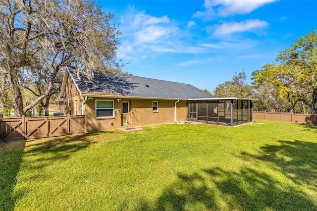 back of house featuring a sunroom and a yard