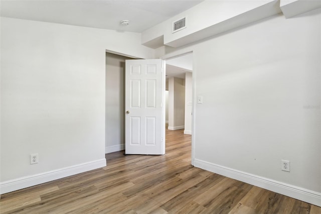 unfurnished room featuring hardwood / wood-style floors