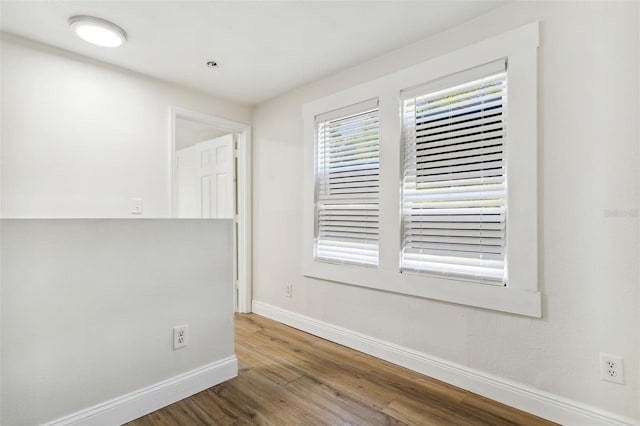 spare room featuring wood-type flooring