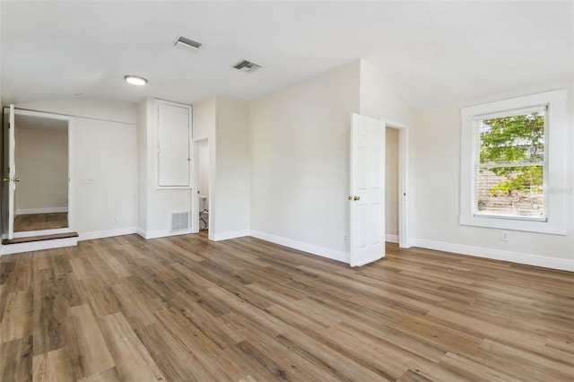 empty room featuring light hardwood / wood-style floors and lofted ceiling