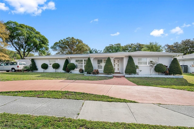 ranch-style house featuring central AC unit and a front yard