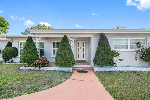 ranch-style home with a front lawn