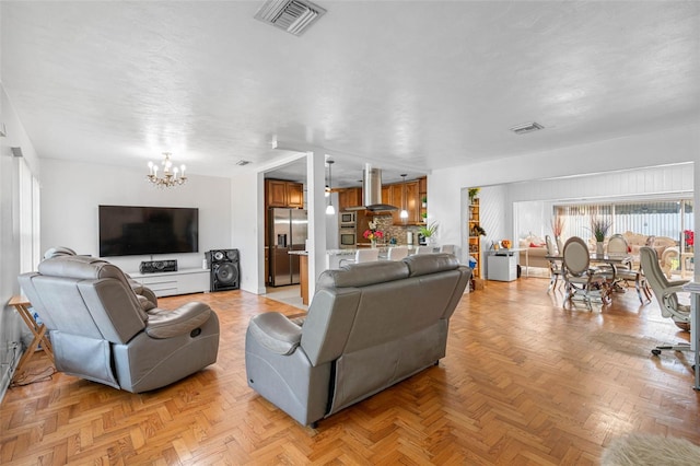 living room with light parquet floors and a chandelier