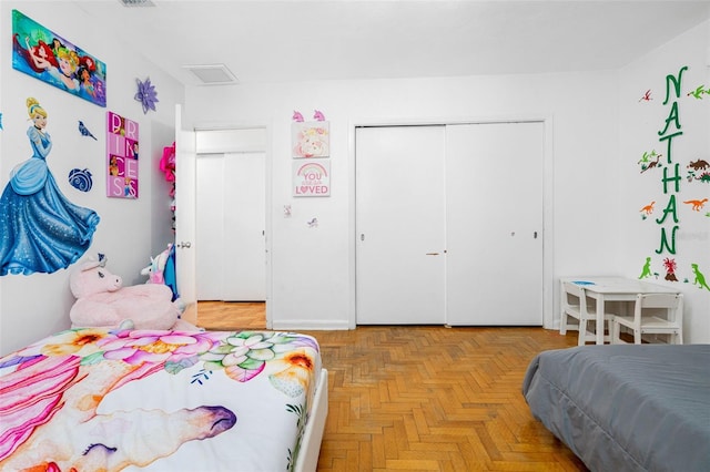 bedroom with a closet and light parquet floors