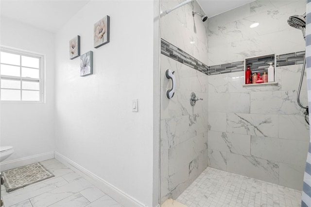 bathroom featuring tiled shower and toilet