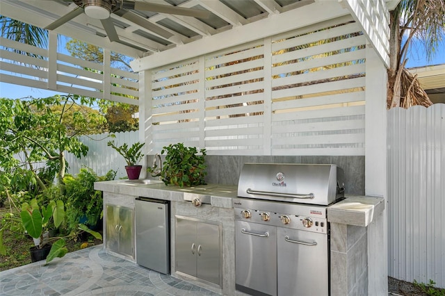 view of patio / terrace with ceiling fan, area for grilling, and sink