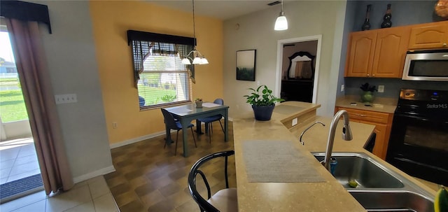 dining room with an inviting chandelier, sink, and tile flooring