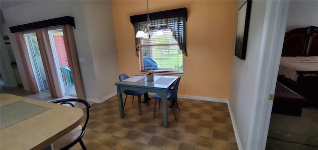 tiled dining space with a notable chandelier