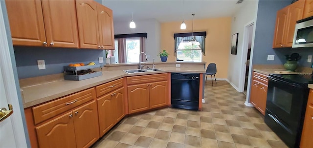 kitchen featuring light tile floors, black appliances, sink, and pendant lighting