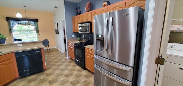 kitchen with pendant lighting, light tile floors, and black appliances