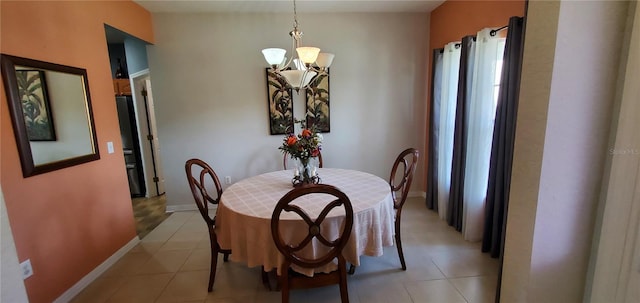 tiled dining space with an inviting chandelier