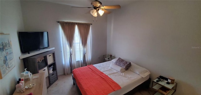 bedroom featuring light colored carpet and ceiling fan