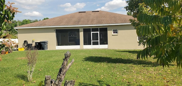 rear view of property with a yard