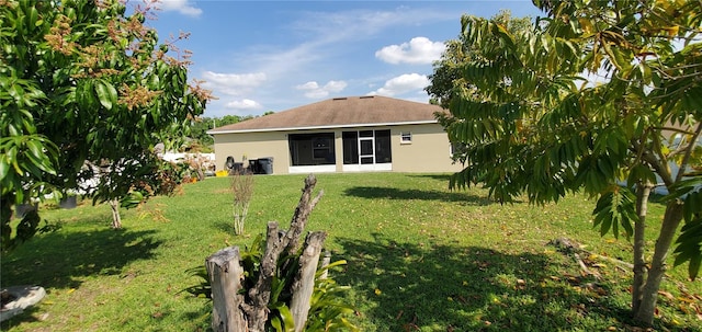 rear view of house featuring a yard