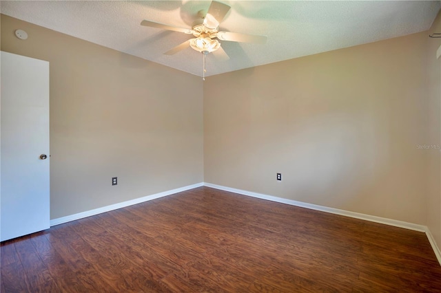 empty room featuring a textured ceiling, ceiling fan, and dark wood-type flooring