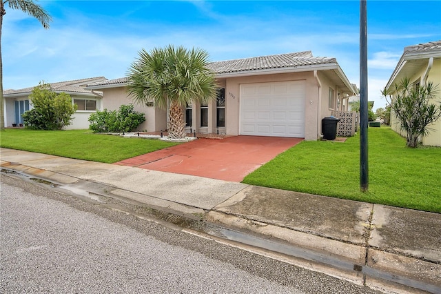 view of front of house with concrete driveway, an attached garage, a front yard, and stucco siding