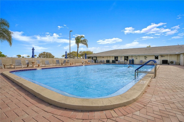 view of pool featuring central AC unit and a patio area