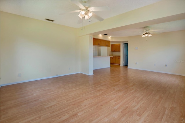 spare room featuring visible vents, baseboards, light wood-type flooring, and ceiling fan