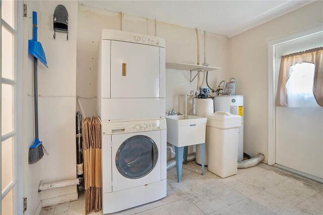 laundry area featuring stacked washer / drying machine