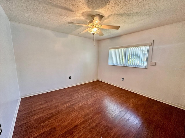 unfurnished room with ceiling fan, baseboards, a textured ceiling, and wood finished floors