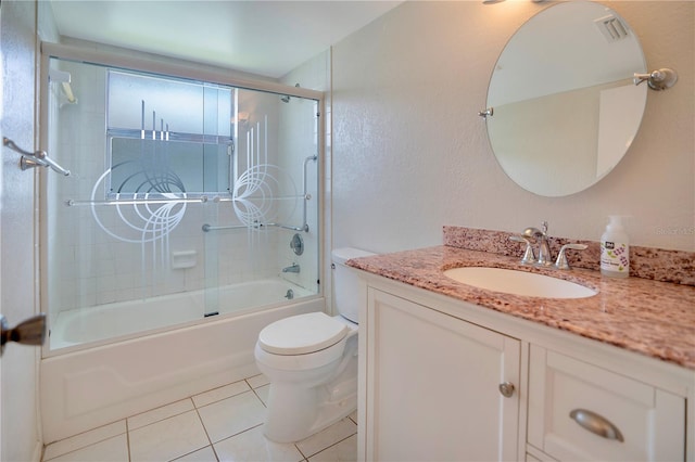 bathroom featuring visible vents, toilet, tile patterned flooring, bath / shower combo with glass door, and vanity