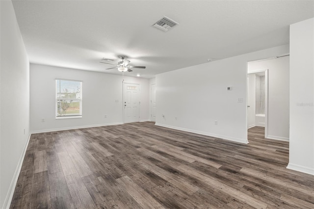 empty room with dark hardwood / wood-style flooring and ceiling fan