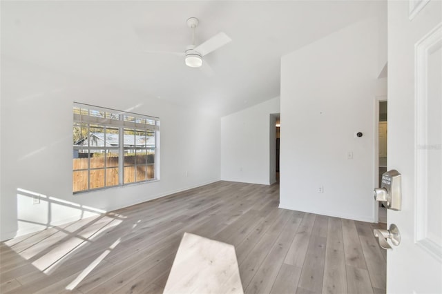 unfurnished room with vaulted ceiling, ceiling fan, and light wood-type flooring