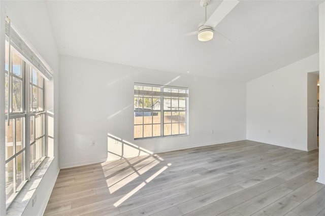 spare room with light hardwood / wood-style floors, ceiling fan, and vaulted ceiling