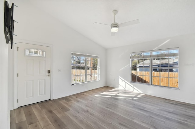 foyer entrance with vaulted ceiling, ceiling fan, and light wood-type flooring