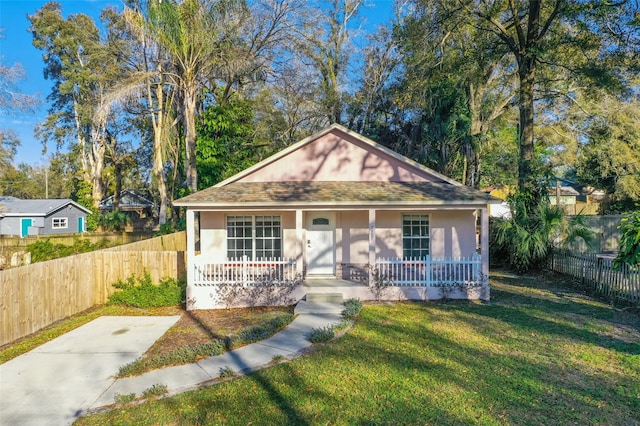 view of front of property with a front yard and covered porch