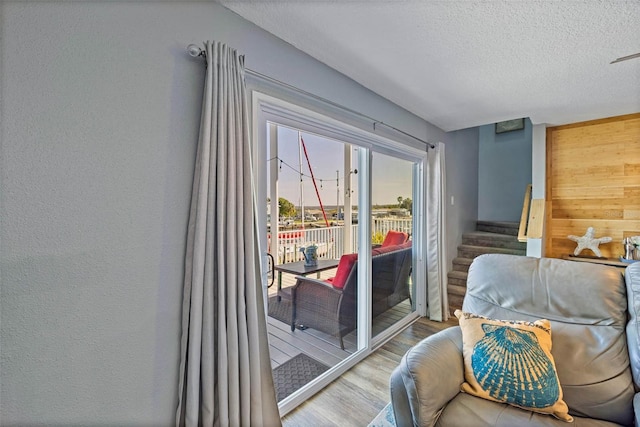 doorway to outside featuring hardwood / wood-style floors and a textured ceiling